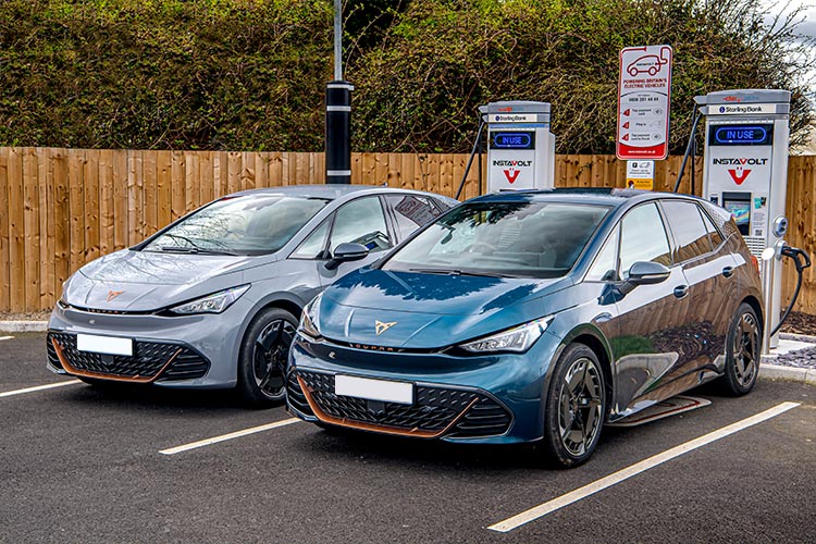 cupra born blue and cupra born grey charging in the station