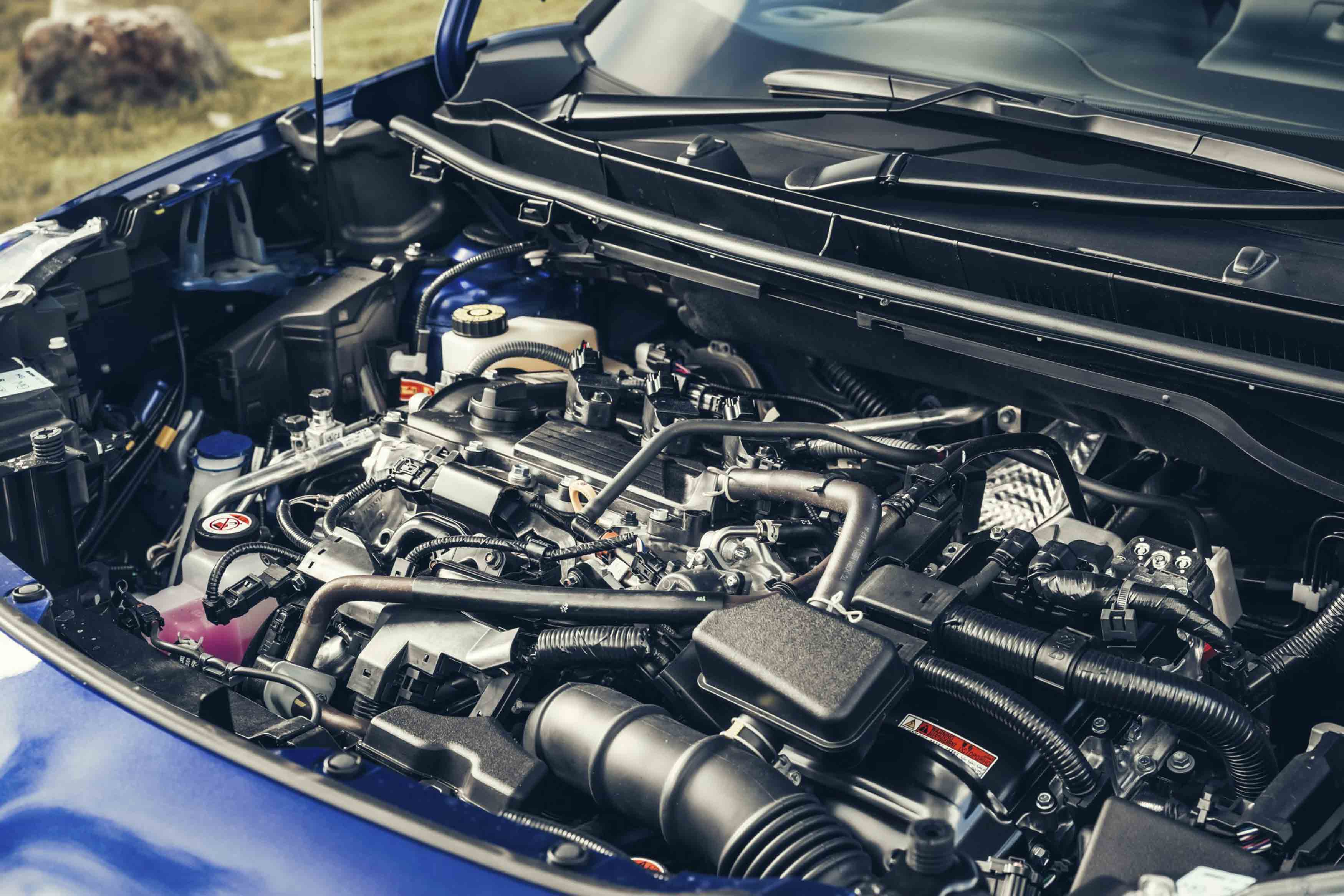 Detailed view of a Toyota car engine, showcasing intricate parts and systems under the hood