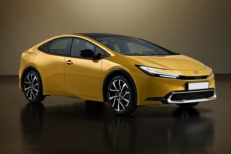 2025 Toyota Prius hybrid sedan in metallic gold color, featuring angular design with black contrast roof and alloy wheels, shown in studio setting