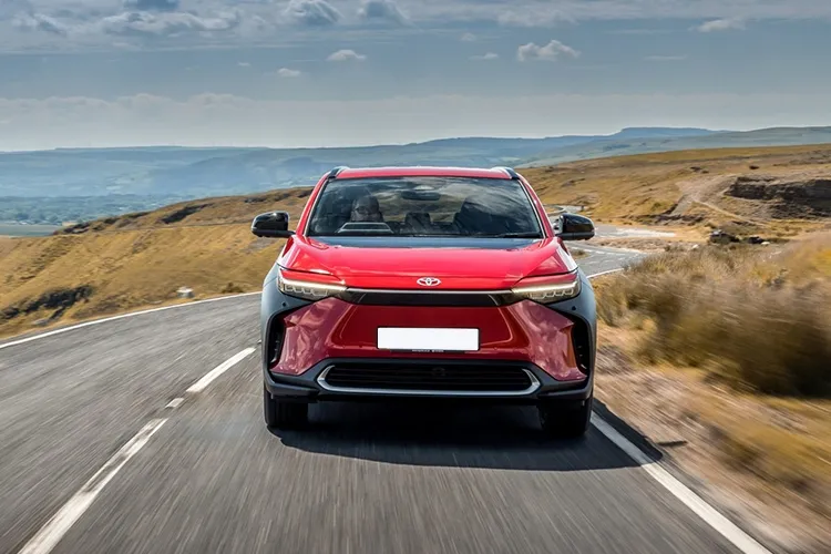 red toyota bz4x in country side cruising